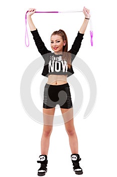 Attractive sporty woman posing holding a skipping rope on white