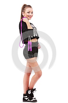 Attractive sporty woman posing holding a skipping rope on white