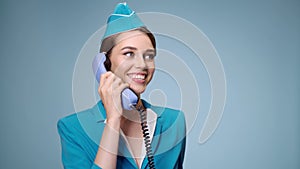 Attractive stewardess in uniform announces information over the phone.