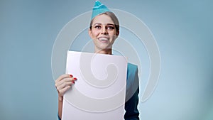 An attractive stewardess in uniform appears with a white letterhead.