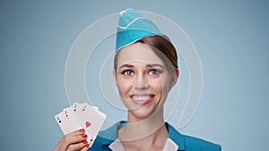 Attractive stewardess in uniform shows four aces in hand.