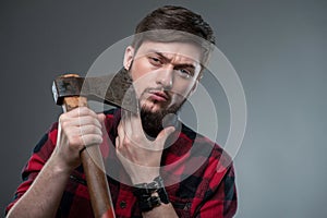 Attractive strong young man with strange axe
