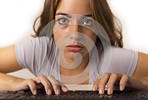 Attractive student girl or working woman sitting at computer desk in stress with tired red eyes after long hours working looking a