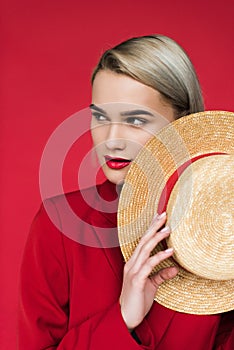 attractive stylish girl in red jacket with straw hat,