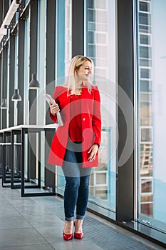 Attractive successful business lady in a red suit