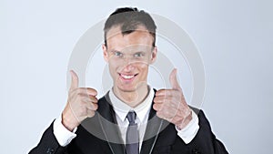Attractive successful smiling businessman with thumb up