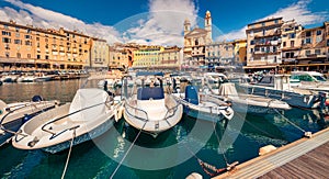 Attractive summer cityscape of Bastia port with twin-towered Church of St. Jean-Baptiste rising behind it.