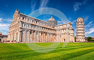 Attractive summer view of famous Leaning Tower in Pisa. Sunny morning scene with hundreds of tourists in Piazza dei Miracoli