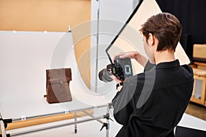 attractive talented female photographer taking photos