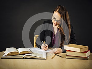 Attractive teacher sitting at her desk writing