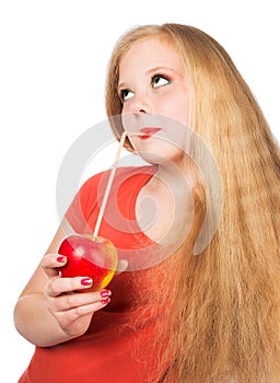 Attractive teen girl in the orange t-shirt holding an red apple