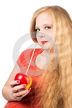 Attractive teen girl in the orange t-shirt holding an red apple