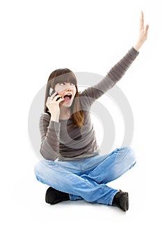 Attractive teenage girl cheering during phone call