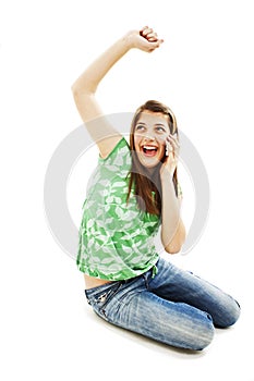 Attractive teenage girl cheering during phone call