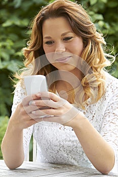 Attractive Teenage Girl Sending Text Message On Phone