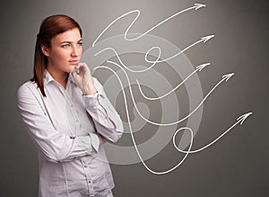 Attractive teenager looking at multiple curly arrows