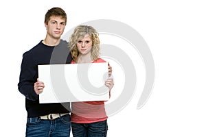 Attractive teenagers holding blank sign