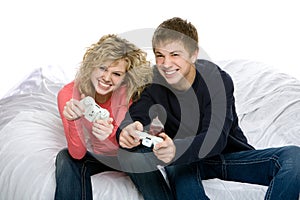 Attractive teenagers playing video games