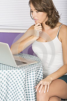 Attractive Thoughtful Annoyed Young Woman Using Laptop Computer