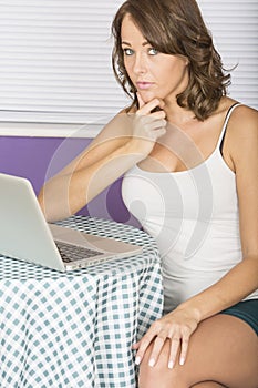 Attractive Thoughtful Annoyed Young Woman Using Laptop Computer