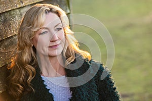 Attractive Thoughtful Middle Aged Woman Outside in Golden Sunshine