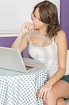 Attractive Thoughtful Pensive Young Woman Using Laptop Computer