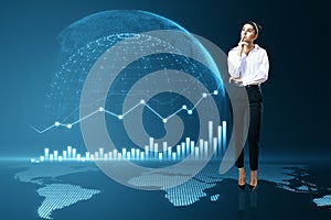 Attractive thoughtful young european businesswoman with abstract digital globe with business chart on blue background. Global