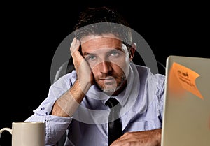 Attractive tired businessman in shirt and tie tired overwhelmed heavy work load exhausted at office