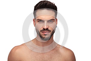 Attractive topless guy with beard looking angry