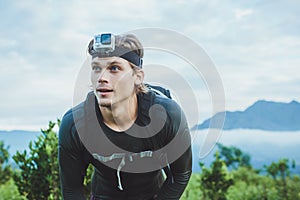 Attractive Traveler vith GoPrO camera on his hand against the Ba