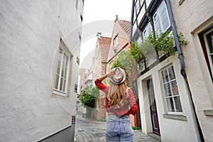 Attractive traveler woman walking in Schnoor neighborhood, Bremen, Germany photo