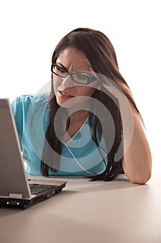 Attractive twenties hispanic nurse on laptop