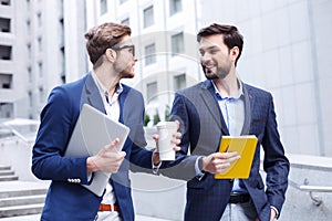 Attractive two businessmen are making a break