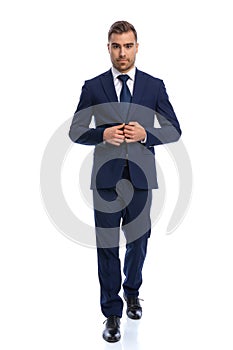 attractive unshaved young model arranging navy blue suit