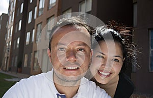 Attractive, very happy young couple embracing and smiling.