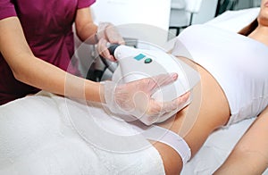 Attractive woman abdomen getting Cool sculpting procedure for body slimming. Cryolipolyse and body contouring treatment,