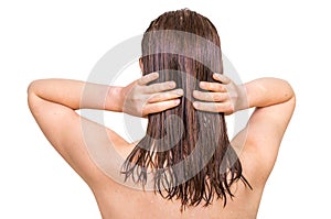 Attractive woman applying conditioner on her hair