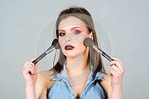 Attractive woman applying makeup brush. Professional makeup supplies. Makeup artist concept. Girl apply powder eye
