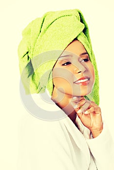 Attractive woman in bathrobe and turban on head