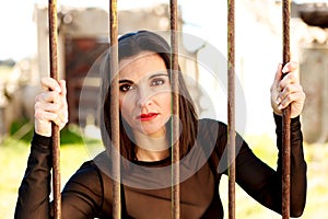 Attractive woman behide the bars photo