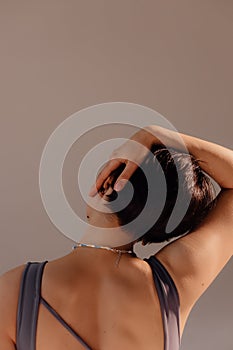 Attractive woman bending body close up. Athletic woman stretches her body on a mat in the studio