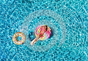 Woman floats over blue pool water