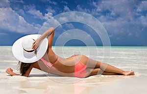 Attractive woman in bikini lying on a beach