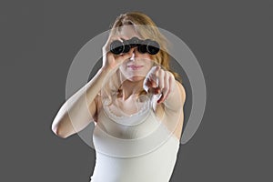 Attractive woman with binoculars and pointing