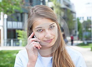 Attractive woman with blond hair listening at phone