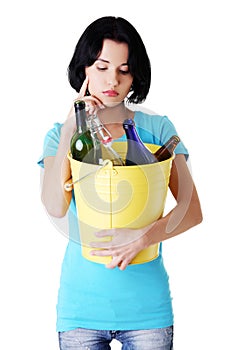 Attractive woman with bottles, recycling idea.