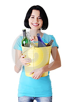 Attractive woman with bottles, recycling idea.