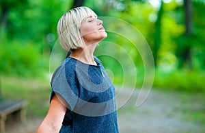 Attractive woman breathing and relaxing outside