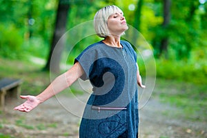 Attractive woman breathing and relaxing outside