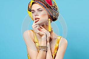 attractive woman bright makeup decoration ethnicity multicolored turban studio blue background